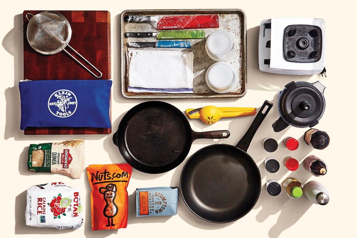 A tray of knives, kitchen towels, spices, coffee, kitchen pots & pans, and a blender