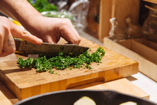 Curly kale being chopped by a knife